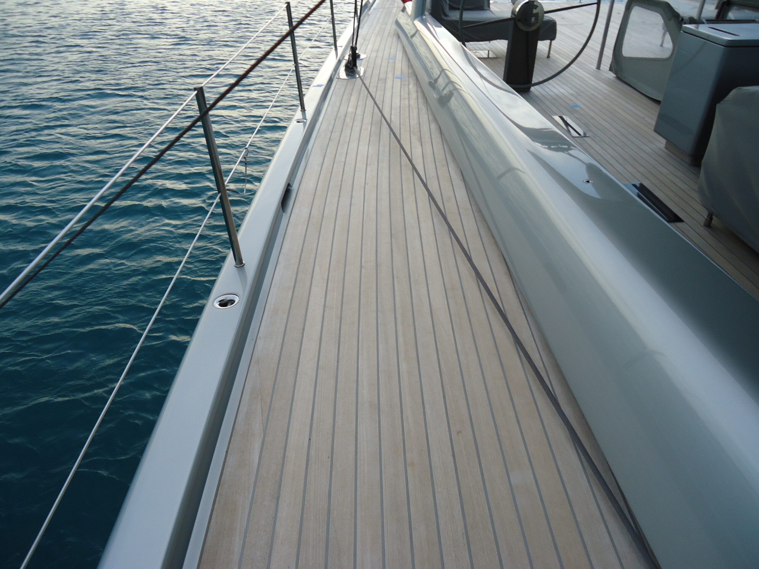 sailboat with teak decking and gray caulking on weather deck