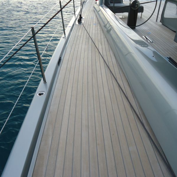 sailboat with teak decking and gray caulking on weather deck