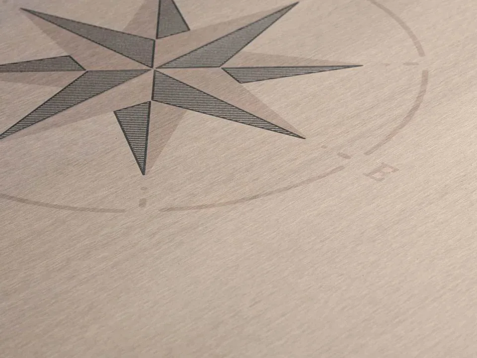 Composite decking with compass rose inlay detail
