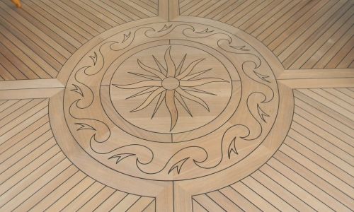Photo of inlaid stylized teak compass rose
