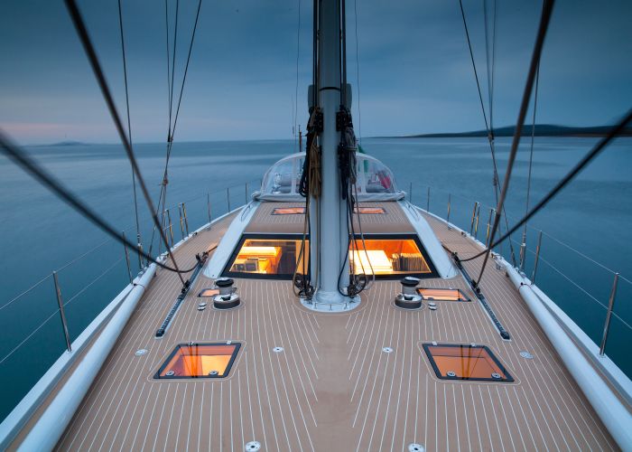 Photo of Composite bow decking on a sailboat with water backdrop faux teak decking
