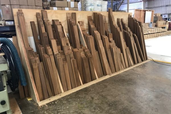 Cut teak stored by lengths in the factory at Teakdecking Systems
