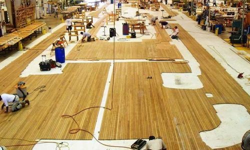 Large teak deck filling manufacturing floor