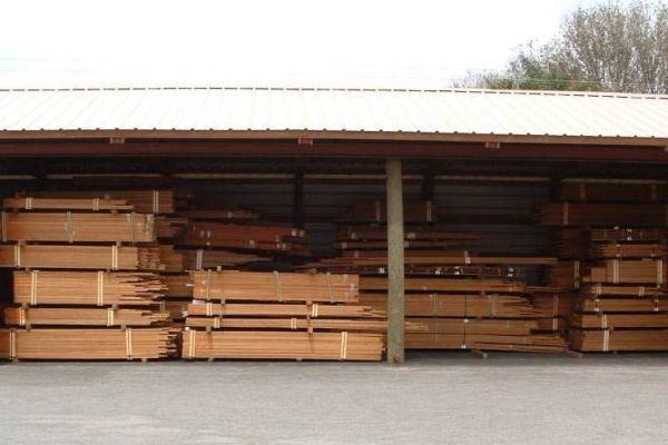 Image of cut teak timber in a storage building at Teakdecking Systems