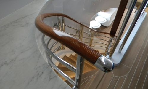 Photo of teak curved stairway handrails on yacht