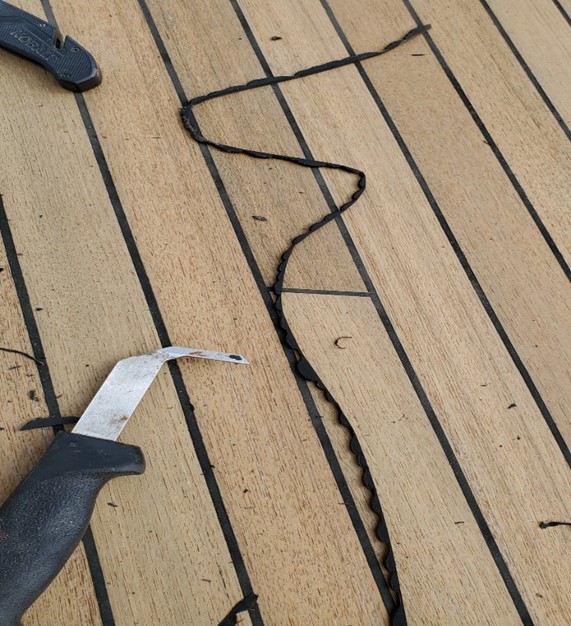 image of caulk removal from a teak deck