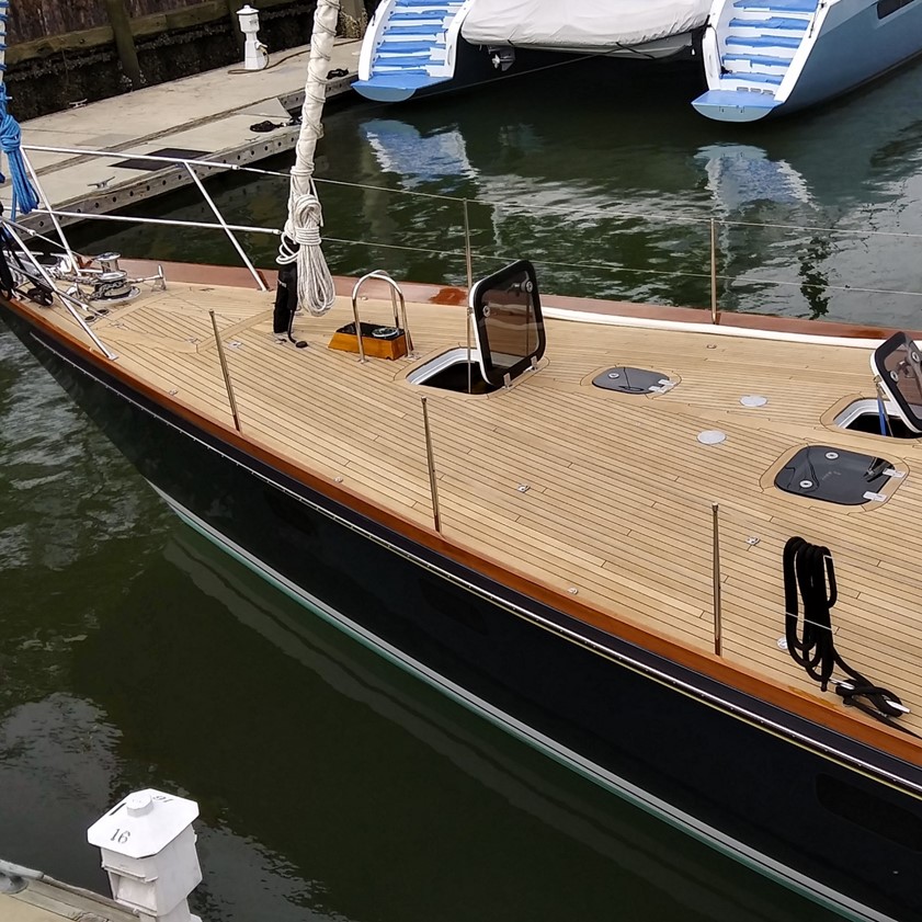 image of freshly sanded teak deck bow of sailboat